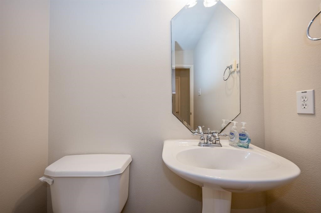 18914 Appletree Ridge Road Houston, TX 77084 - Photo 26 of 31 a bathroom with a sink a toilet and mirror