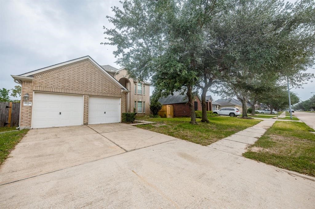 18914 Appletree Ridge Road Houston, TX 77084 - Photo 28 of 31 a front view of house with yard and green space