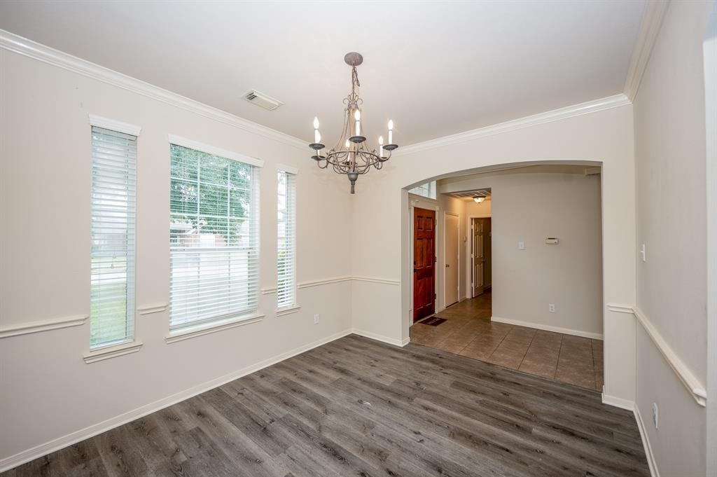18914 Appletree Ridge Road Houston, TX 77084 - Photo 3 of 31 a view of a room with wooden floor and chandelier
