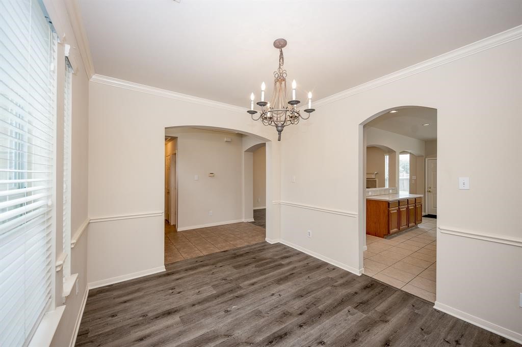 18914 Appletree Ridge Road Houston, TX 77084 - Photo 4 of 31 a view of a room with wooden floor staircase and a kitchen