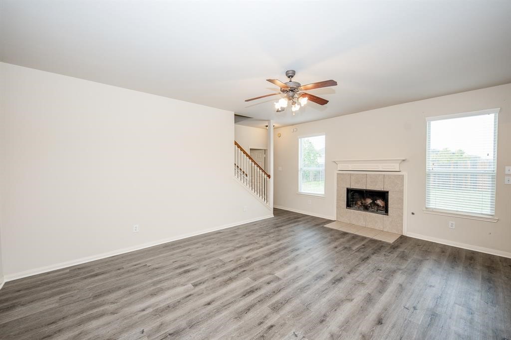 18914 Appletree Ridge Road Houston, TX 77084 - Photo 9 of 31 an empty room with wooden floor and fireplace
