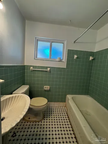 a bathroom with a toilet a sink and bathtub