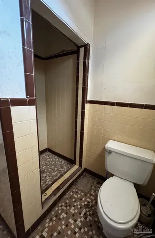 a white toilet sitting next to a sink