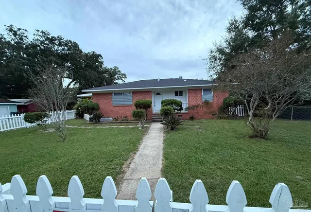 a front view of house with a garden and porch