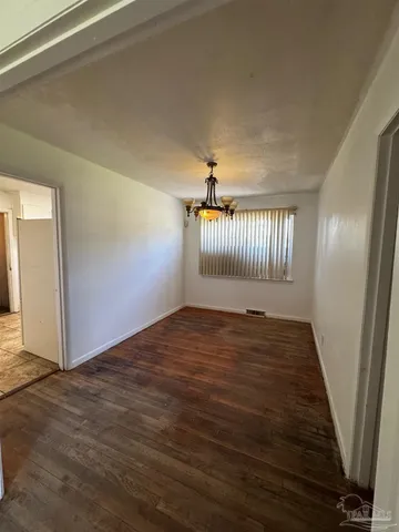 a view of an empty room and wooden floor