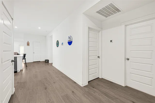 a kitchen with a sink white cabinets and stainless steel appliances