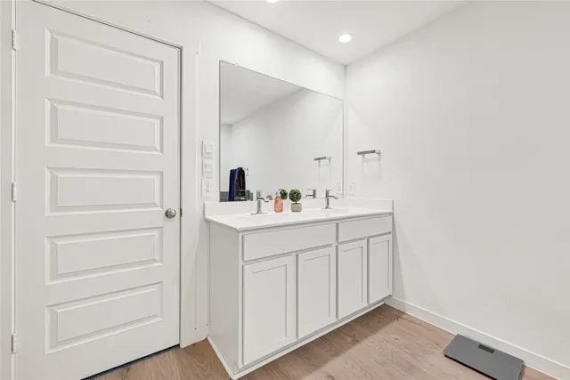 a bathroom with a shower a sink and mirror
