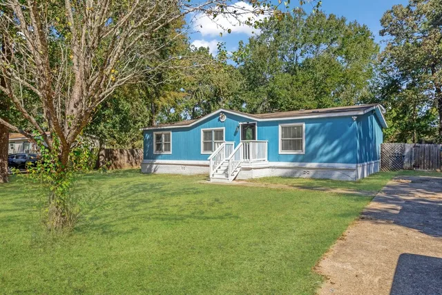 a front view of house with yard and green space