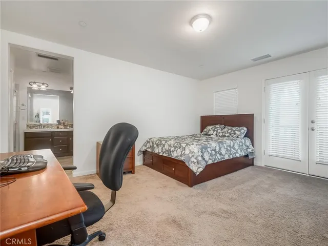 a bedroom with a bed and a desk