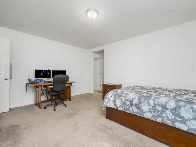 a bedroom with a workspace