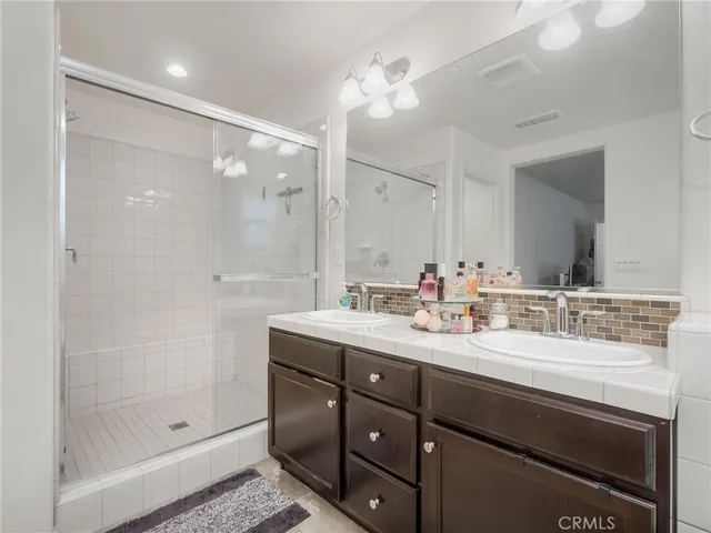 a bathroom with a sink double vanity and a mirror