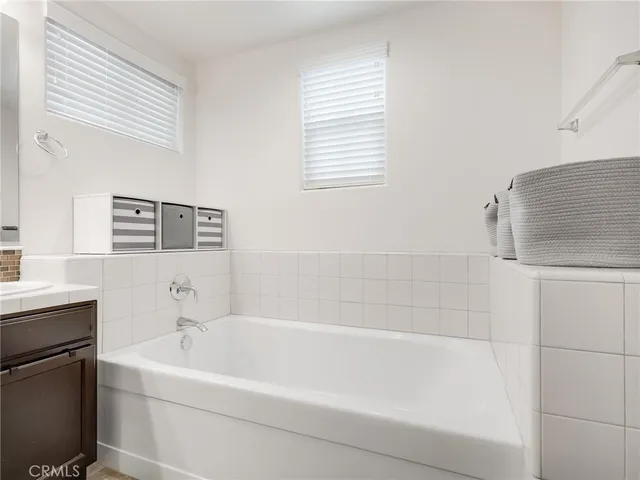 a white bath tub sitting next to a white sink