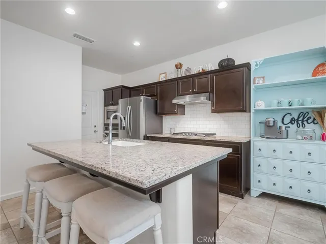 a kitchen with a stove a sink and a refrigerator