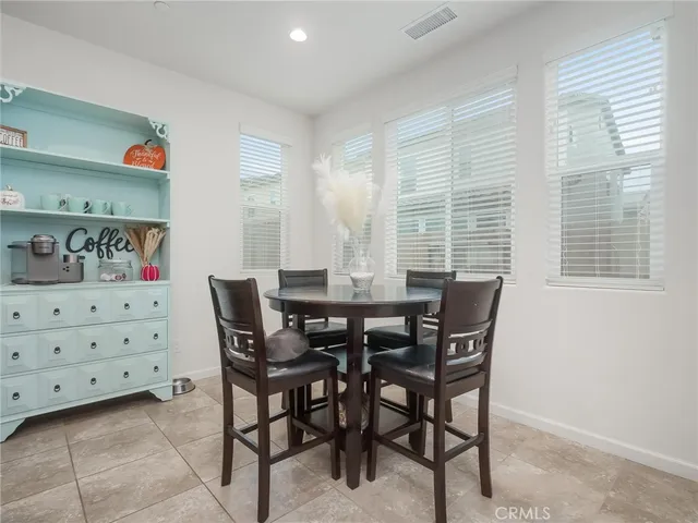 a view of a dining room with furniture and window