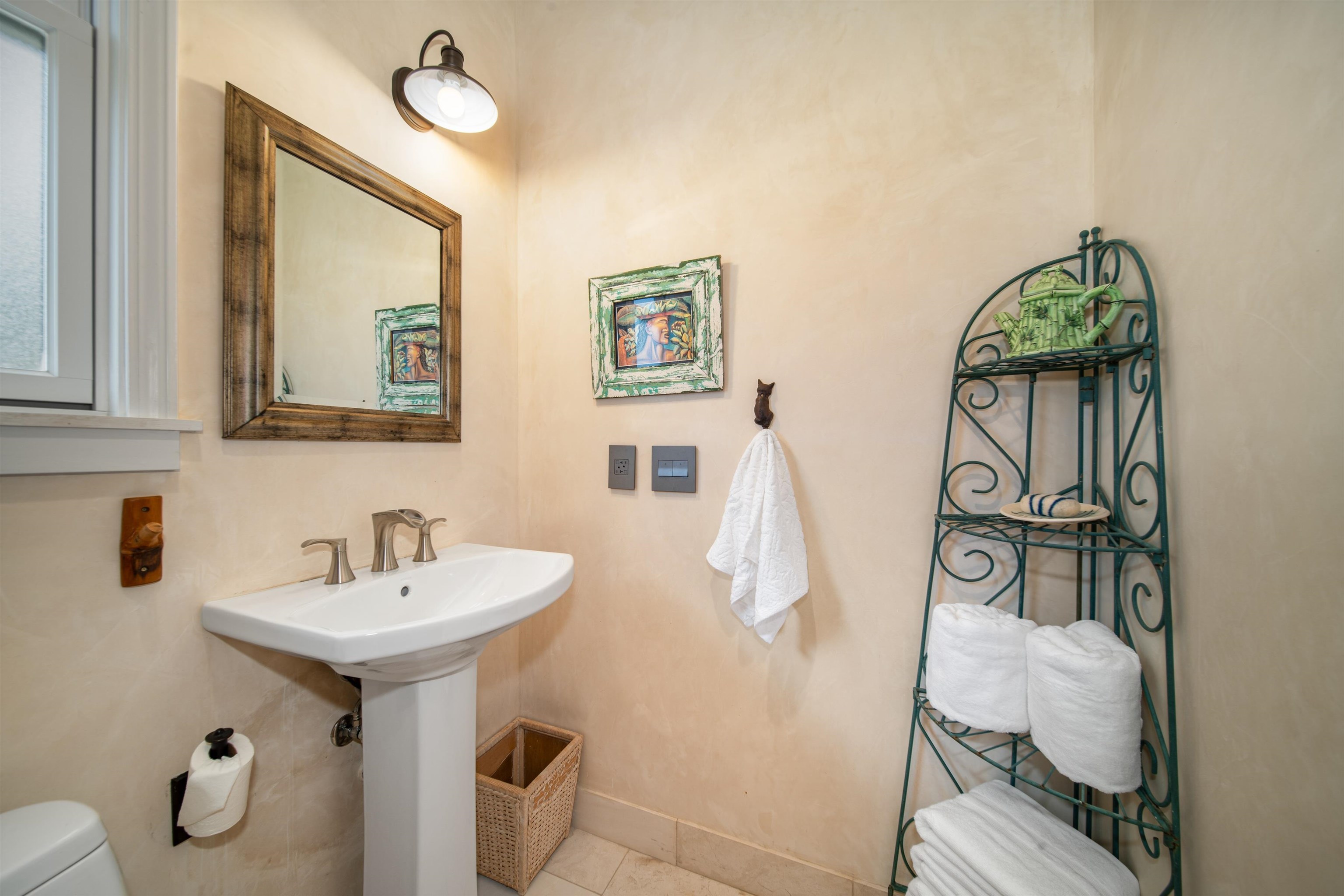 95 North Holokai Road Haiku, HI 96708 - Photo 15 of 40 a bathroom with a sink and mirror with toilet
