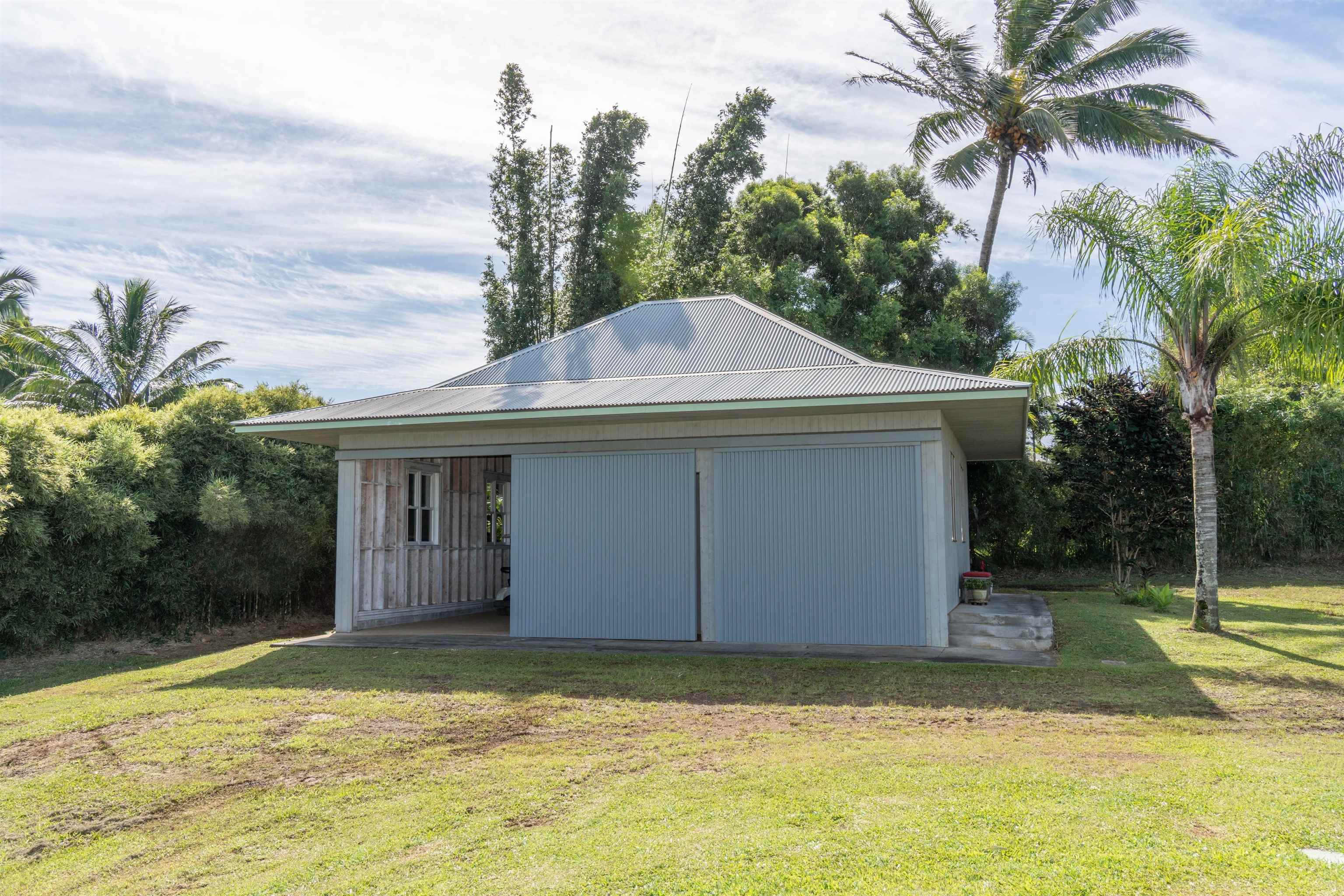 95 North Holokai Road Haiku, HI 96708 - Photo 26 of 40 a view of a house with a yard and garage