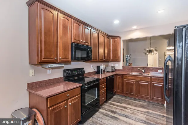 a view of a dining room with furniture wooden floor and chandelier