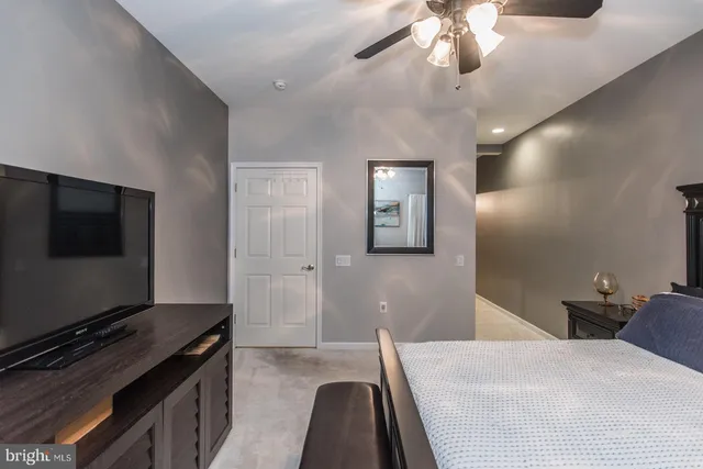a bathroom with a glass shower door and a mirror