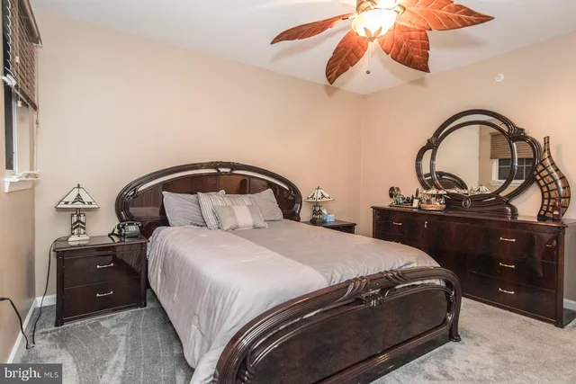 a bedroom with a bed and ceiling fan