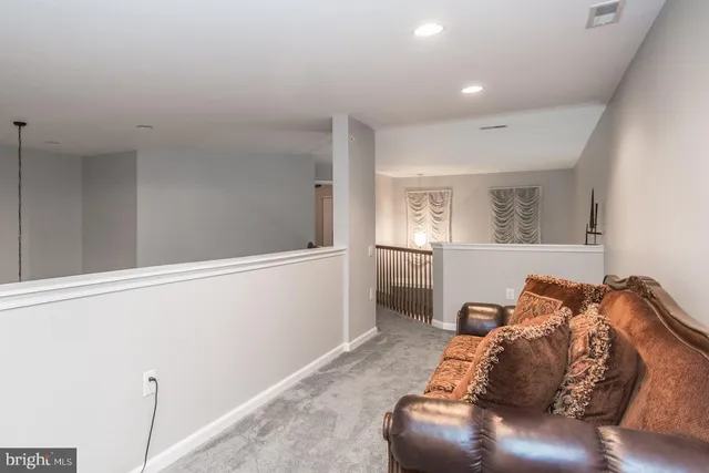 a bedroom with a bed and a mirror on dresser