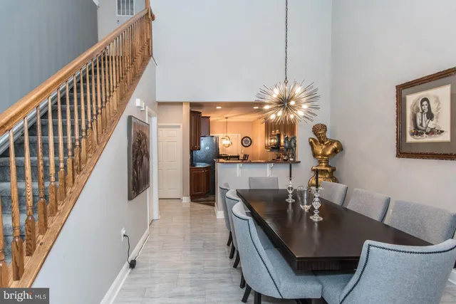 a dining room with furniture and wooden floor