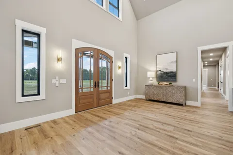a living room with furniture and floor to ceiling window
