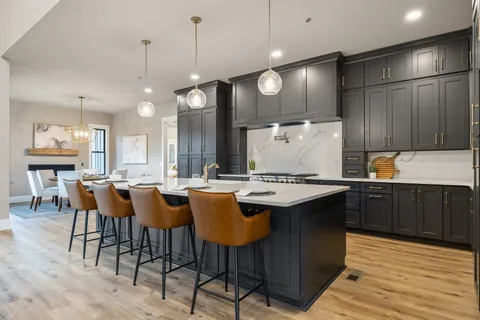 a kitchen with counter top space and wooden floor