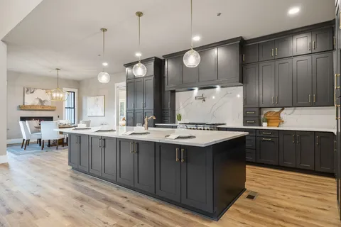 a dining room with furniture a chandelier and wooden floor