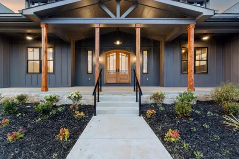 a living room with fireplace furniture and a large window