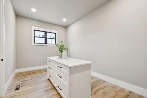 a living room with furniture and a large window with wooden floor