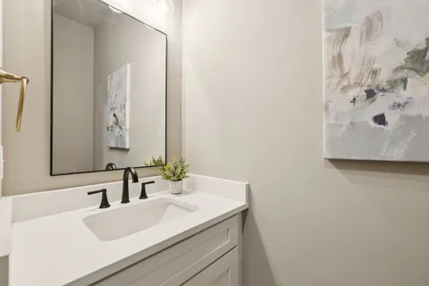 a living room with furniture kitchen view and a large window