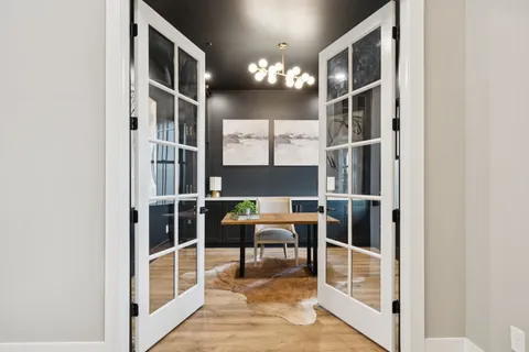 a living room with furniture and large windows