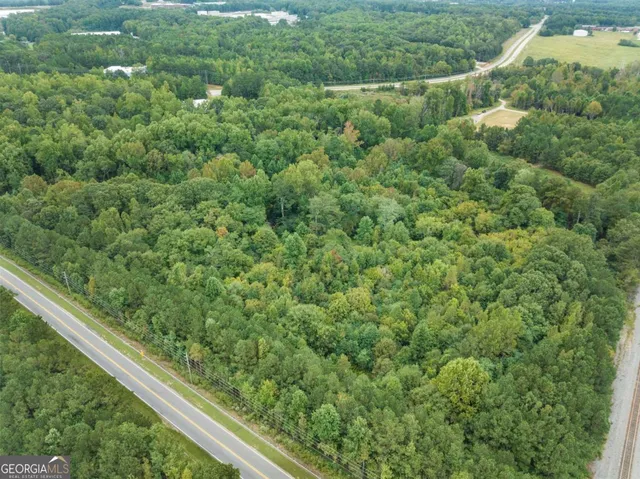 a view of a green field with lots of trees in it