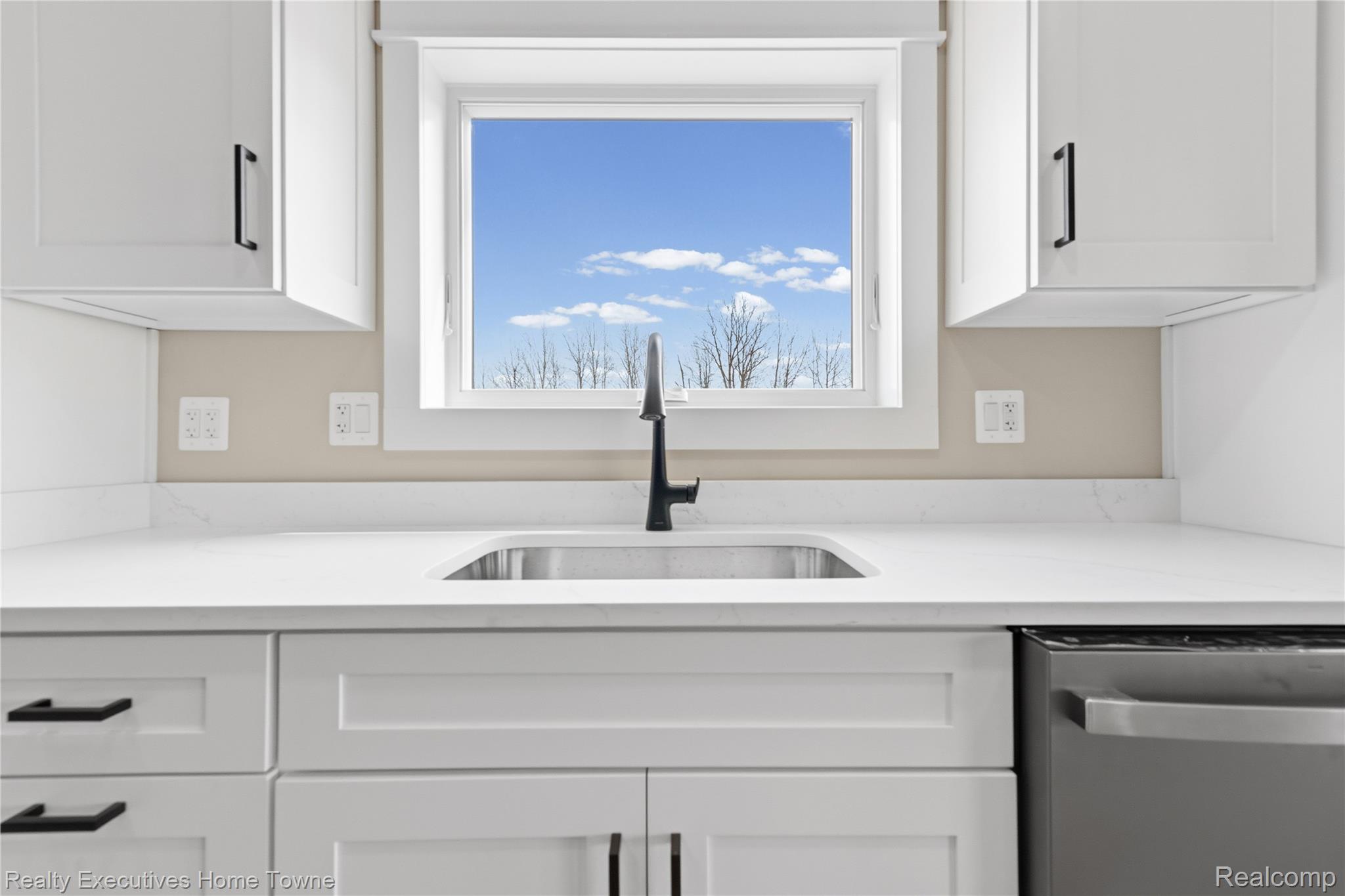 26850 Irwin Road Richmond, MI 48062 - Photo 6 of 47 Kitchen with white cabinets, stainless steel dishwasher, and light stone countertops