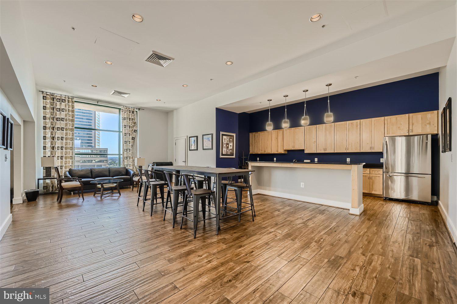 414 Water Street, Unit 2302 Baltimore, MD 21202 - Photo 27 of 34 a kitchen with a table and chairs in it