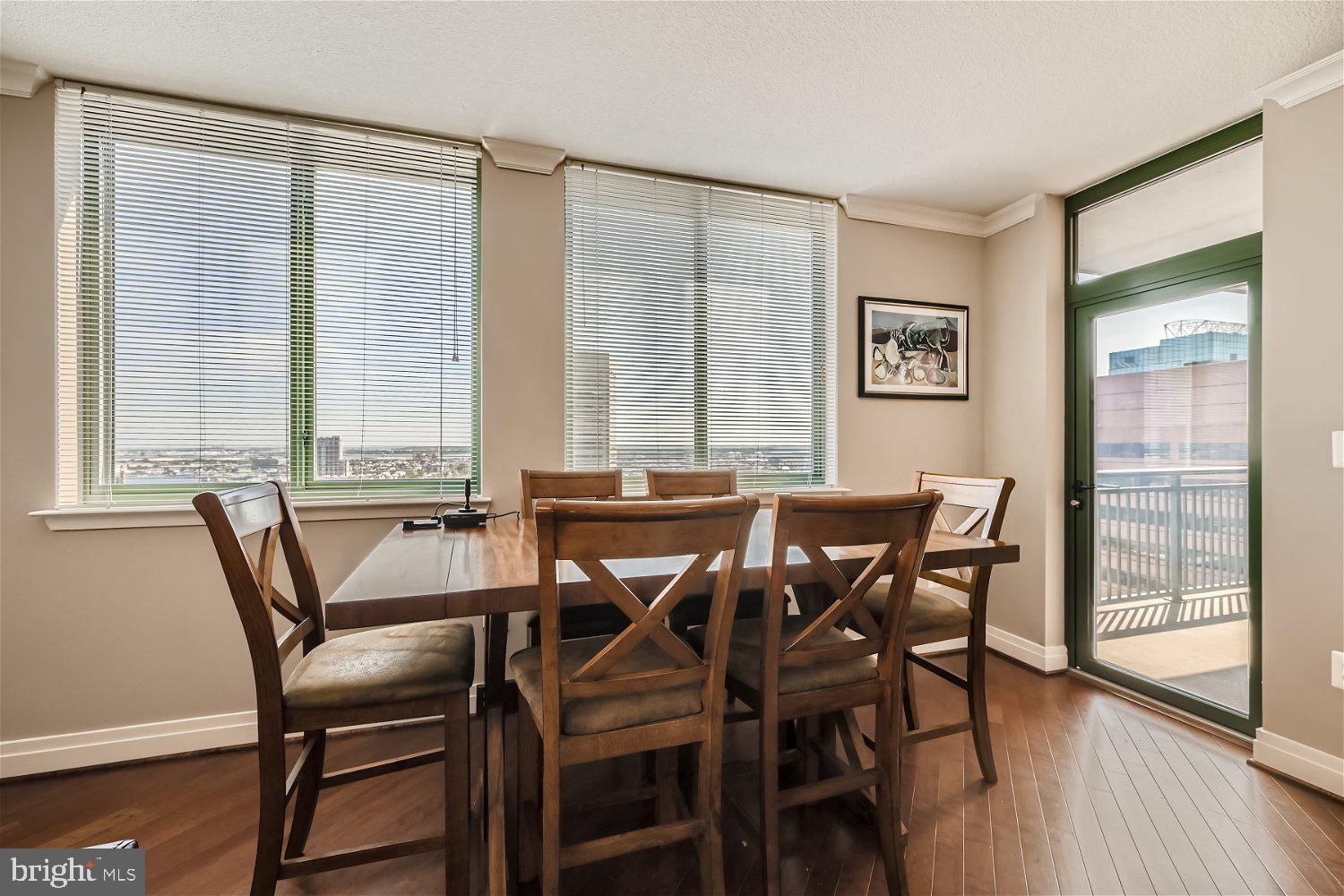 414 Water Street, Unit 2302 Baltimore, MD 21202 - Photo 6 of 34 a view of a dining room with furniture and wooden floor