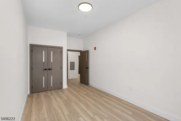 a view of a room with wooden floor and bathroom