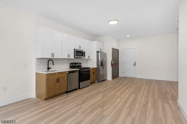a kitchen with stainless steel appliances a refrigerator sink and stove