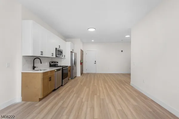 a kitchen with cabinets and stainless steel appliances