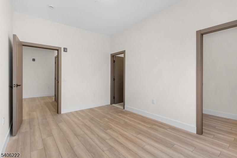 87-89 Mary Street, Unit 503 Paterson, NJ 07503 - Photo 8 of 14 a view of a hallway with wooden floor