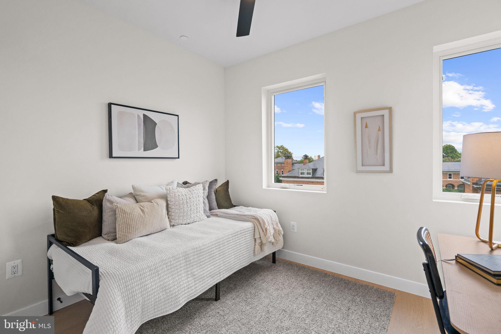 733 8th Street Southeast, Unit 303 Washington, DC 20003 - Photo 12 of 18 a bedroom with a bed and a chair