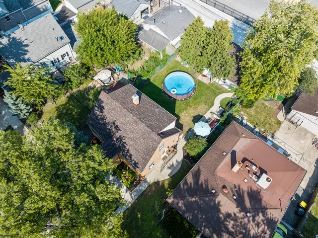 an aerial view of a house with a swimming pool