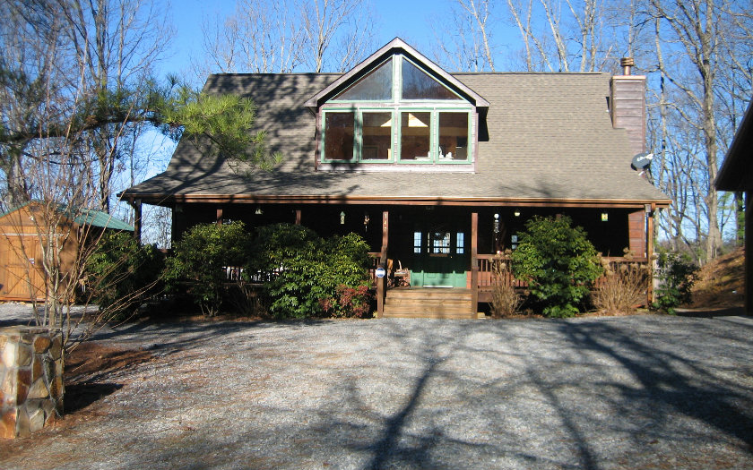 147 Deep Gap Road Blue Ridge, GA 30513 - Photo 1 of 1 a front view of house with yard and trees in the background