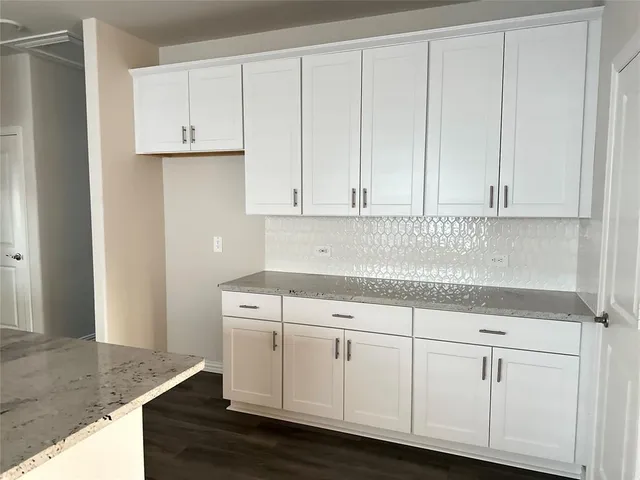 a kitchen with white cabinets