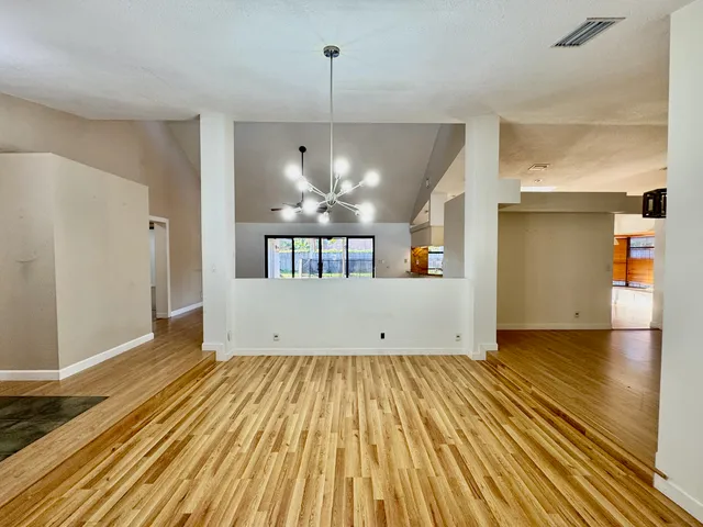 a view of a room with wooden floor