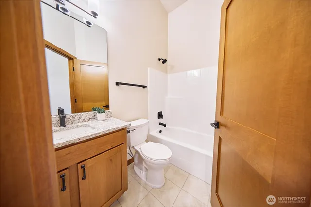 a view of a hallway with wooden floor and entryway