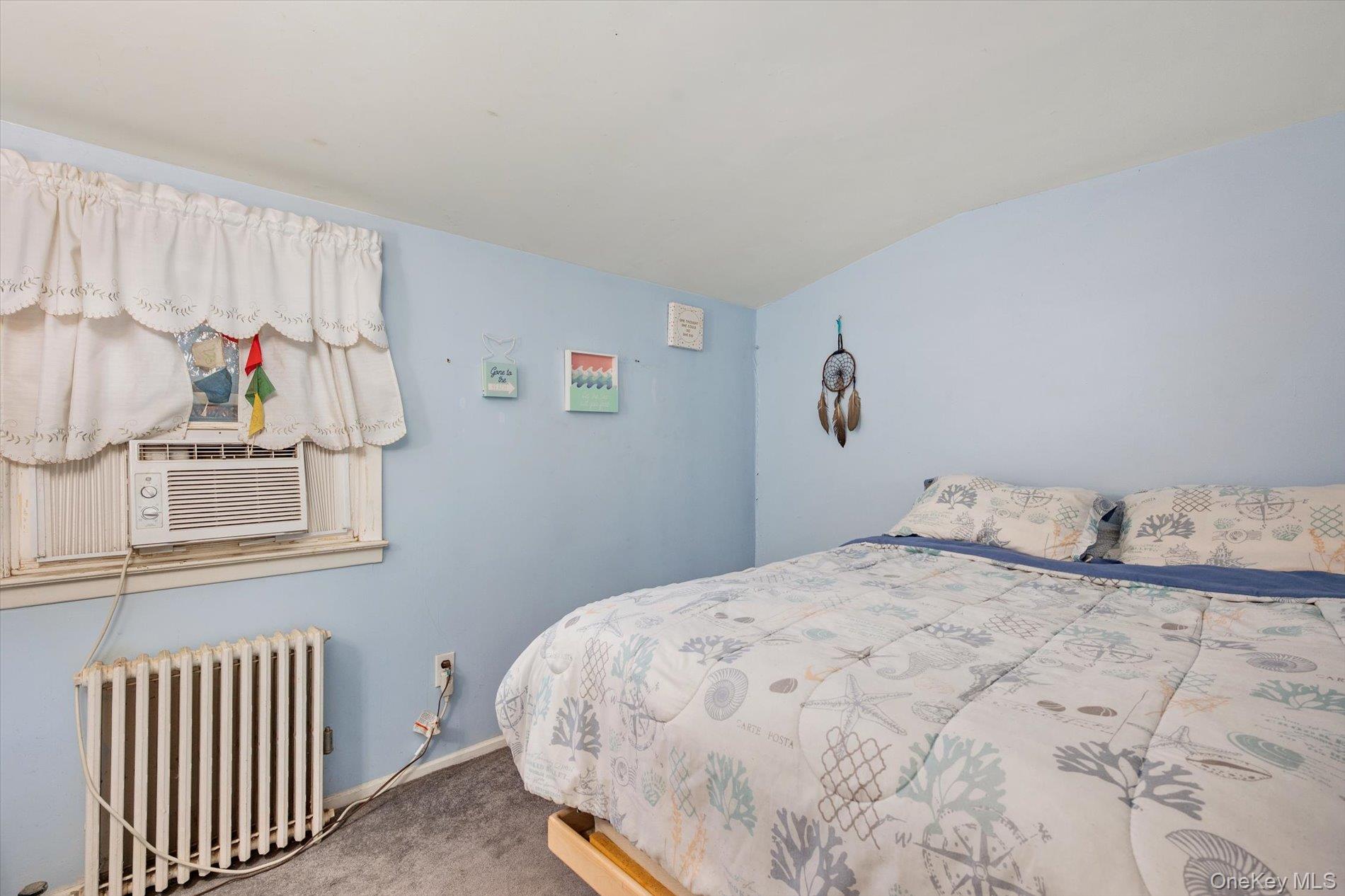 2271 Locust Street Merrick, NY 11566 - Photo 13 of 24 a bedroom with a bed and window