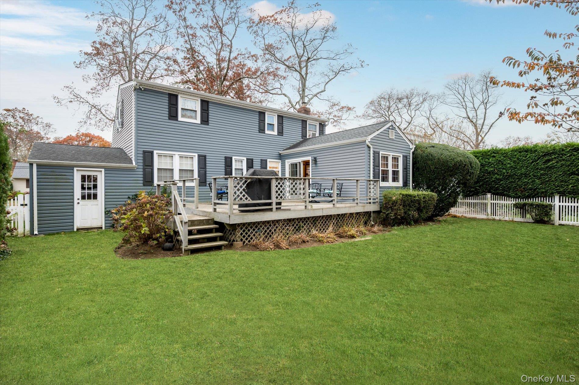 2271 Locust Street Merrick, NY 11566 - Photo 19 of 24 a view of house with a big yard and large trees