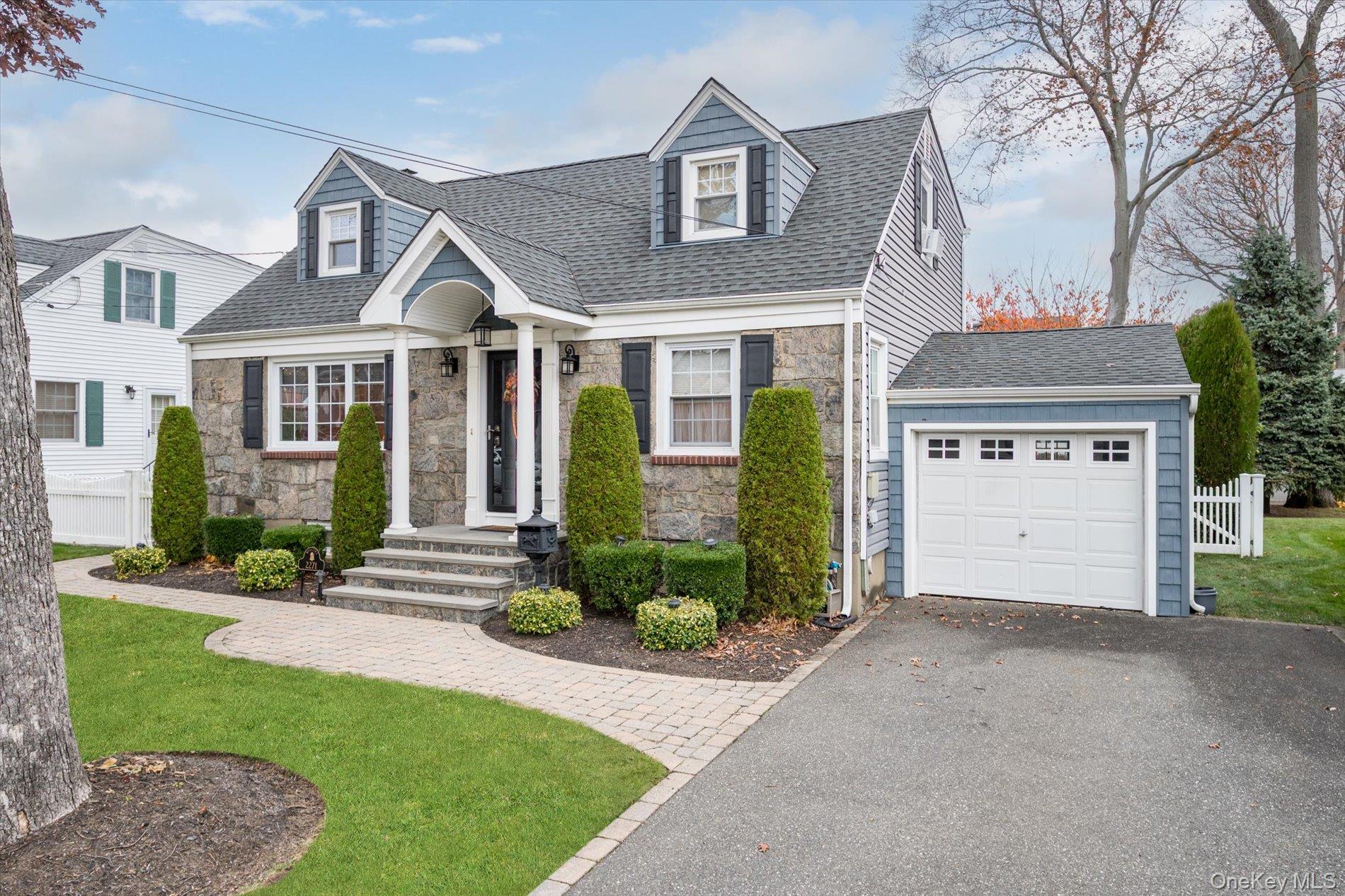 2271 Locust Street Merrick, NY 11566 - Photo 2 of 24 front view of a house with a yard