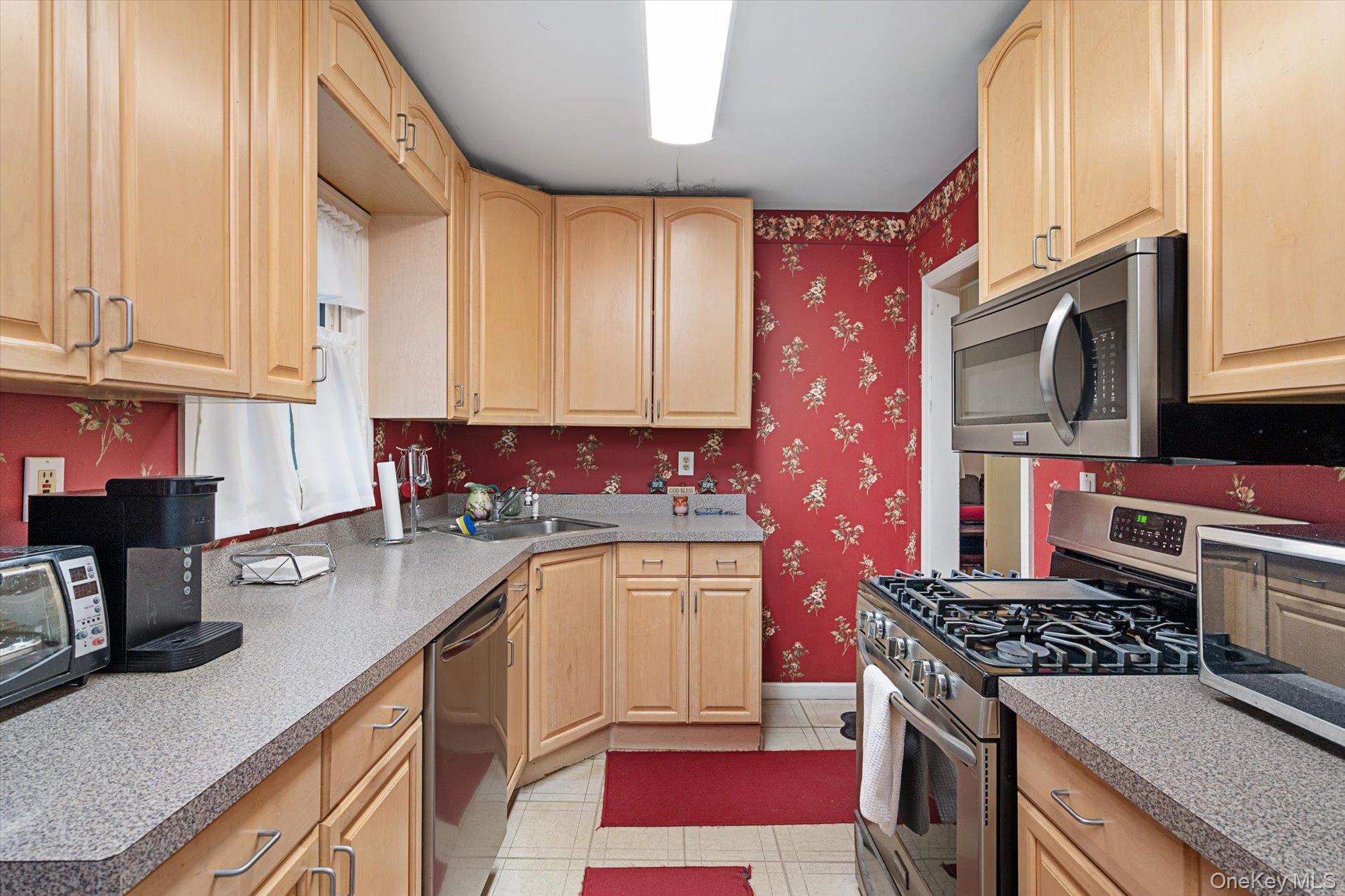 2271 Locust Street Merrick, NY 11566 - Photo 4 of 24 a kitchen with stainless steel appliances granite countertop a stove a sink and a microwave